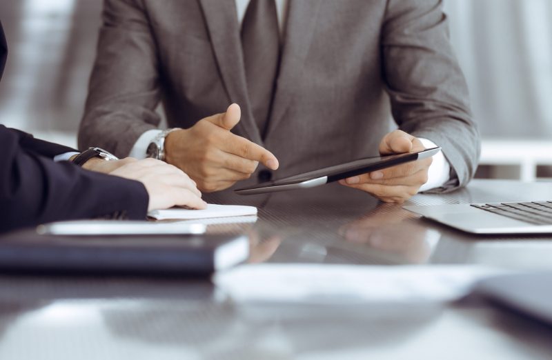Unknown,Businessman,Using,Tablet,Computer,And,Working,Together,With,His